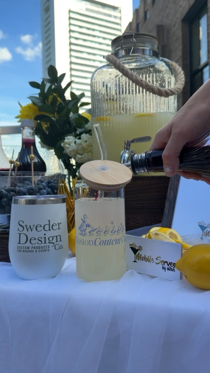A branded tumbler bar — custom Sweder Design Co. and Boston Content Club tumblers styled at a rooftop event