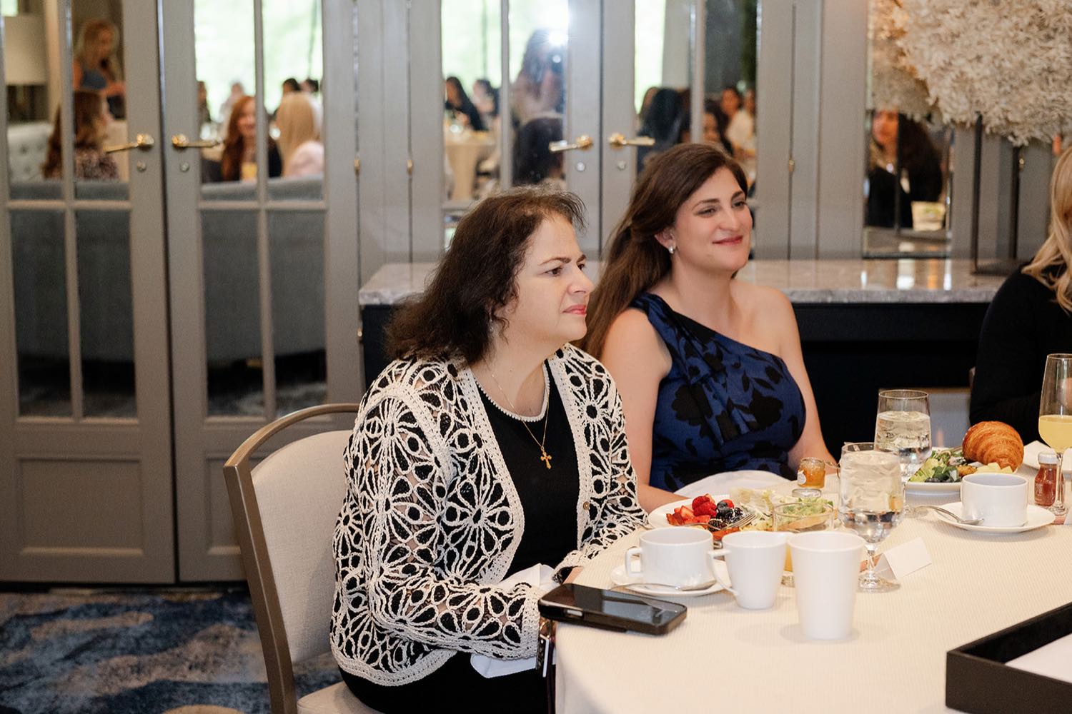 Two guests connecting at a Bold Moves networking brunch