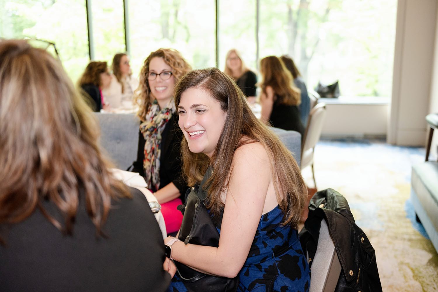 A guest connecting and laughing at a Bold Moves networking brunch